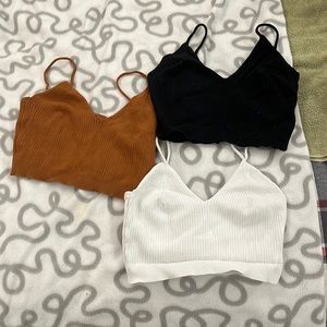 I’m selling these three cropped tank tops they’re white black and dark orange